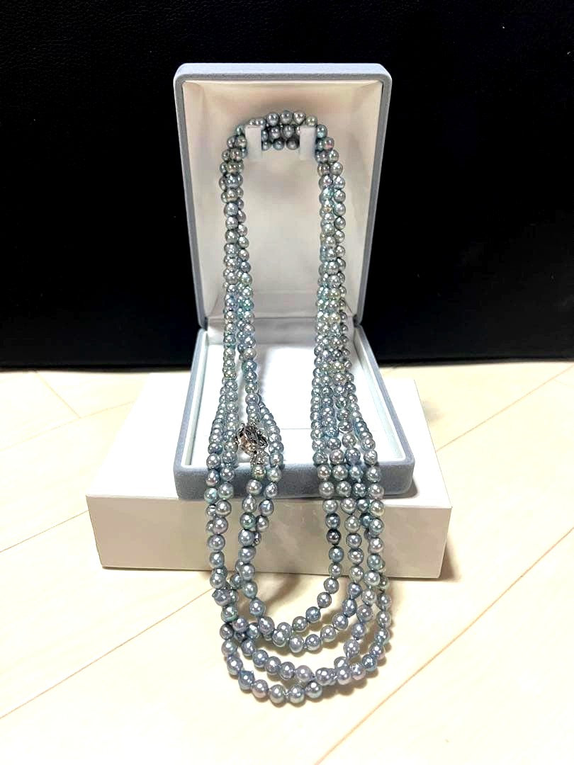 Akoya pearl long necklace in blue silver color made with pearls and silver shown on a white background
