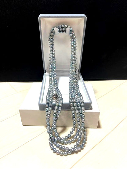 Akoya pearl long necklace in blue silver color made with pearls and silver shown on a white background