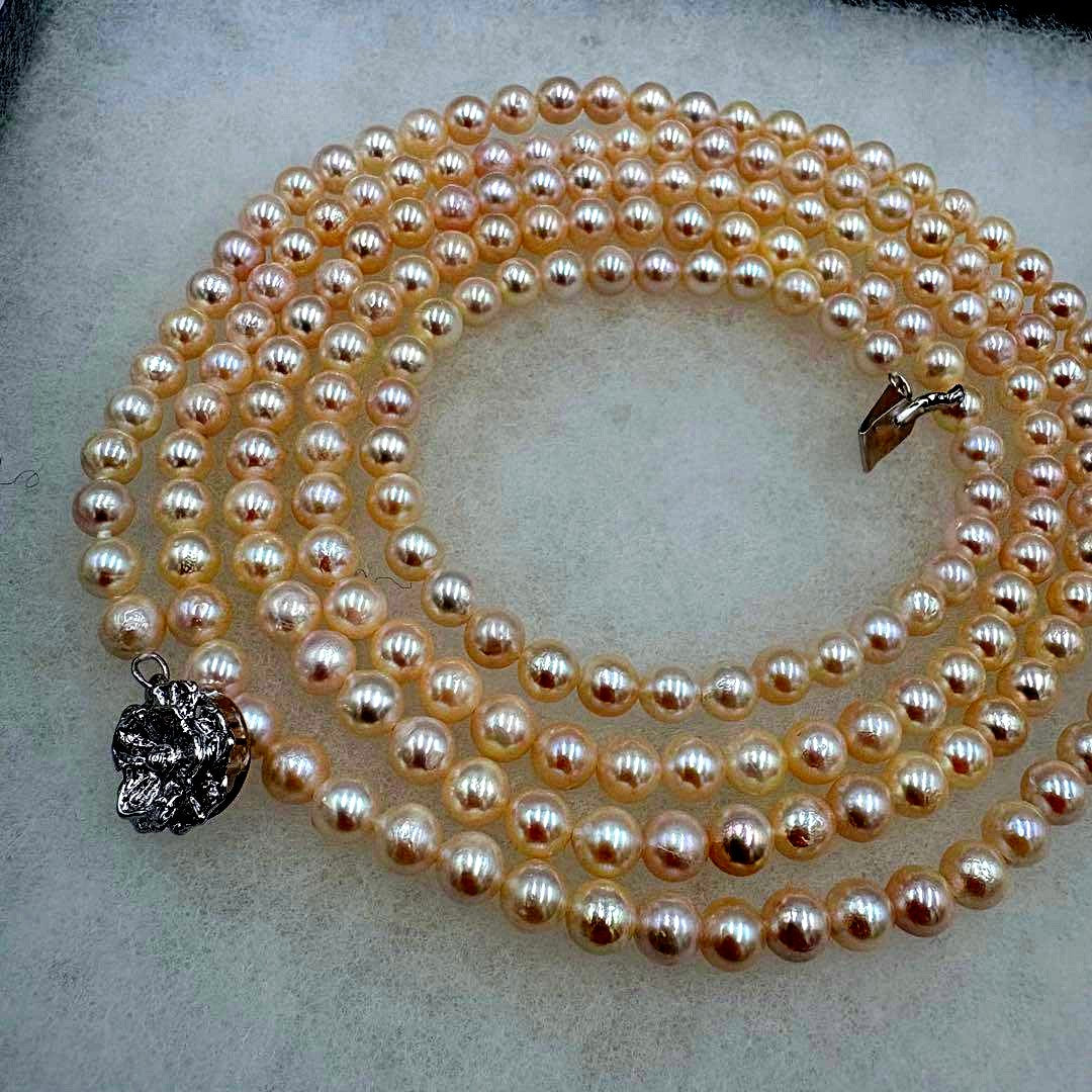 Long Akoya pearl necklace measuring 126cm with round 6.5mm white pearls on display