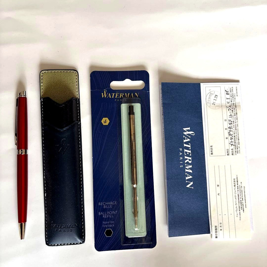 Waterman red ballpoint pen with black ink and leather case embossed with Waterman Paris logo