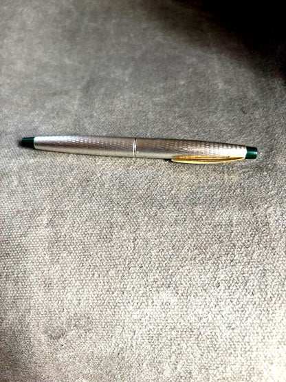 Pilot 14k 585 fountain pen with silver grid pattern body and green accents showing slight dent