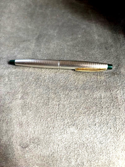 Pilot 14k 585 fountain pen with silver grid pattern body and green accents showing slight dent