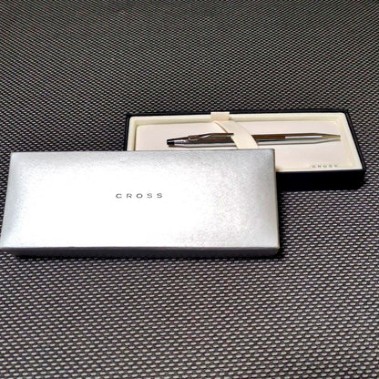 Silver Cross ballpoint pen with twist mechanism alongside its gift box and instruction manual