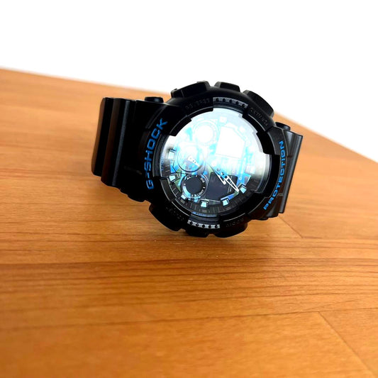 Casio G-Shock GA-100CB-1AJF watch with blue camouflage dial and black resin case