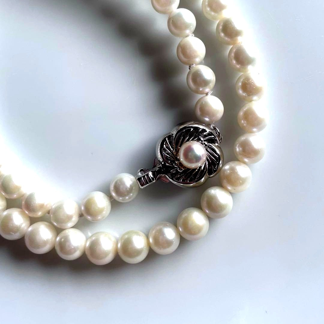Akoya pearl necklace with white 6.0 to 6.5mm pearls and silver clasp on a white background