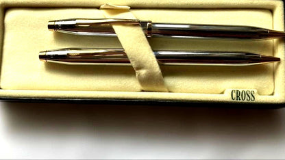 Cross ballpoint pen and mechanical pencil set with sleek silver finish on white background