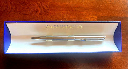 Silver WATERMAN PARIS ballpoint pen with slim body and clip on a white background