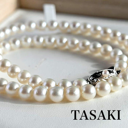 Tasaki Akoya Pearl Necklace featuring 7mm round pearls and a silver clasp on a white background