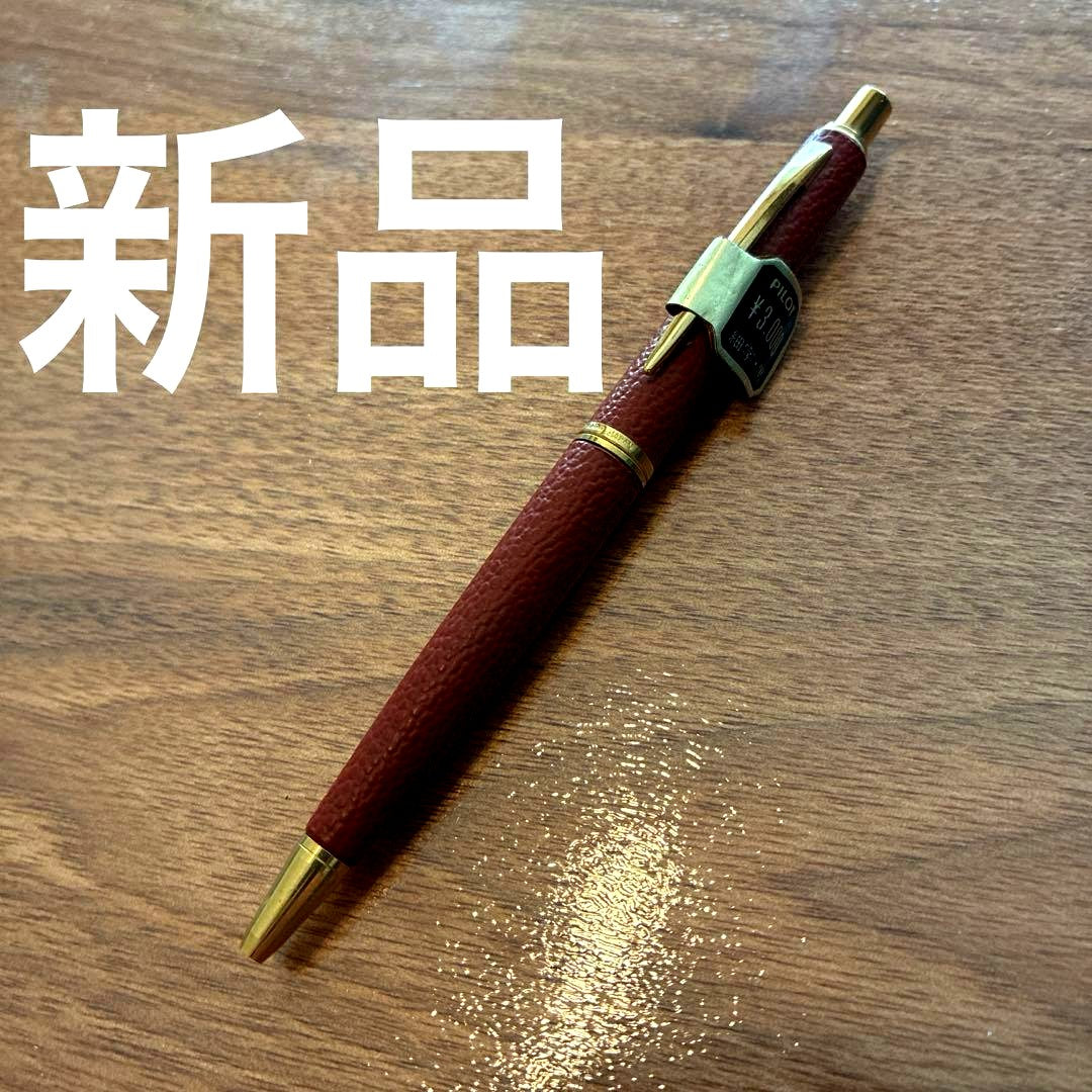 New PILOT high-end ballpoint pen with brown leather-like body and gold accents, fine point tip, black ink
