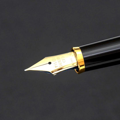Pilot fountain pen with 14k gold fine nib, black and gold body, and blue-black ink cartridge included