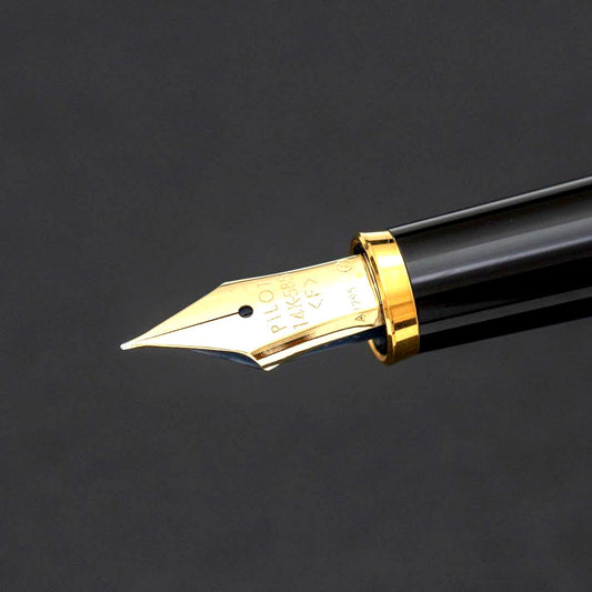 Pilot fountain pen with 14k gold fine nib, black and gold body, and blue-black ink cartridge included