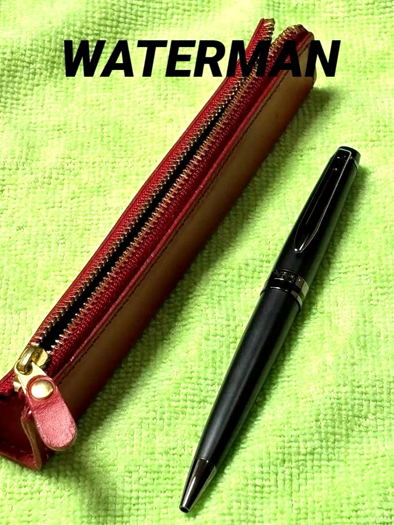 Red leather pencil case measuring 14 cm with a black Waterman pen set displayed together