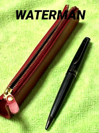 Red leather pencil case measuring 14 cm with a black Waterman pen set displayed together