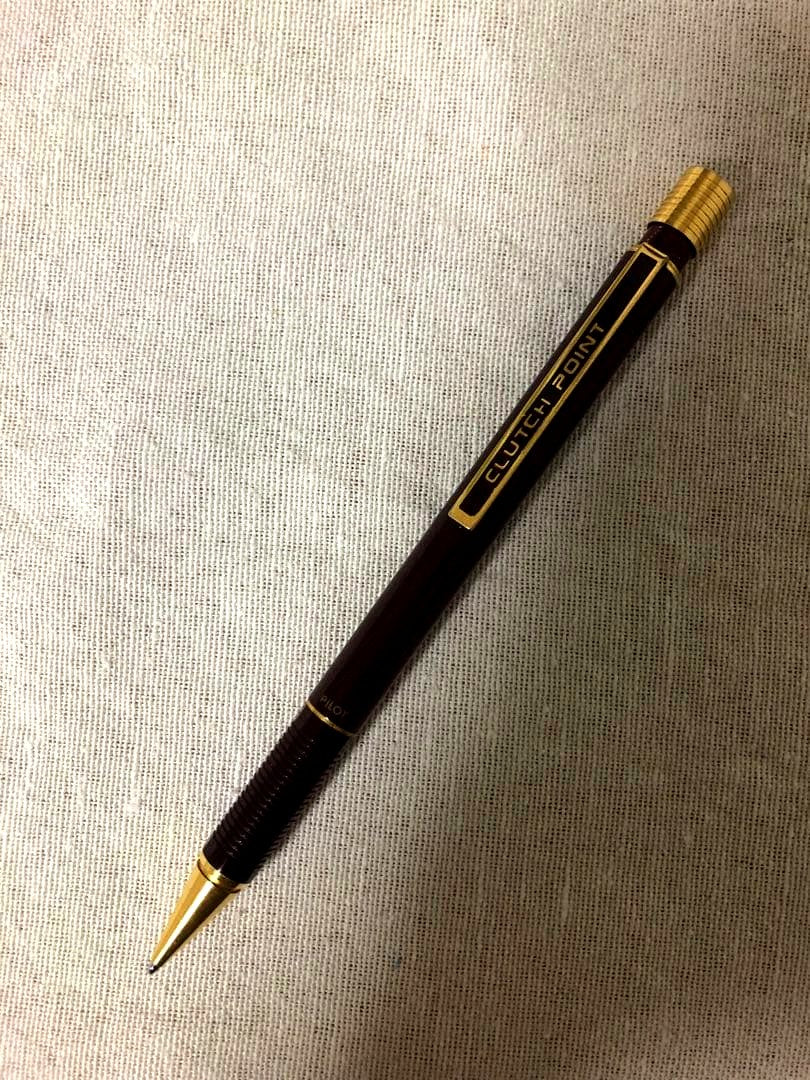 Pencil with chuck tip in reddish tone color and light rust metal parts