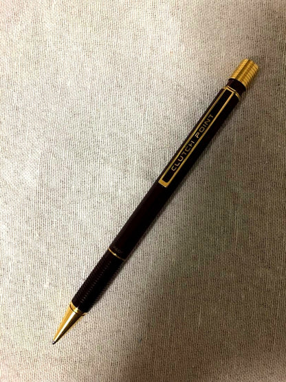 Pencil with chuck tip in reddish tone color and light rust metal parts