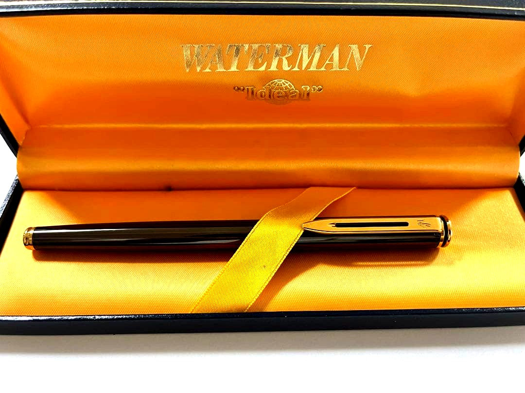 Vintage Waterman fountain pen shown with its protective case on a white background