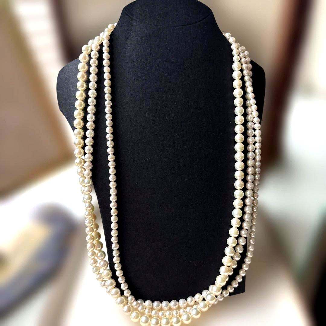 Akoya pearl necklace with three strands of varying sized white pearls, approximately 45cm long, displayed with case