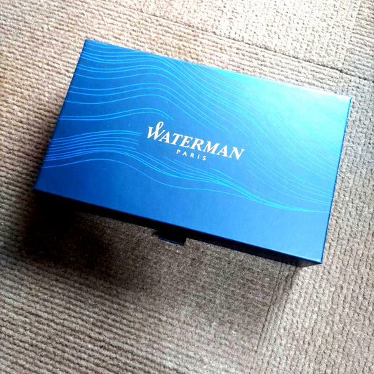 WATERMAN ballpoint pen with light pink body and silver trim, displayed with matching pen case