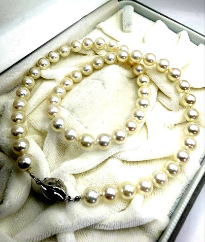 Hon-Pearl Akoya pearl necklace with 7mm white round beads displayed on a black background