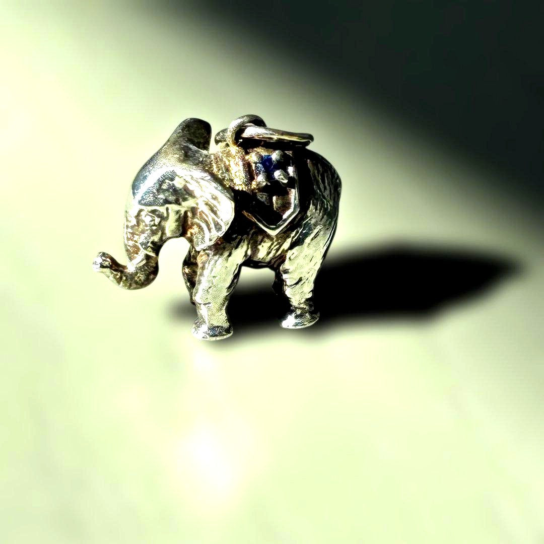 Agete Elephant Pendant Top with emerald and sapphire side stones showing tarnish and black spots