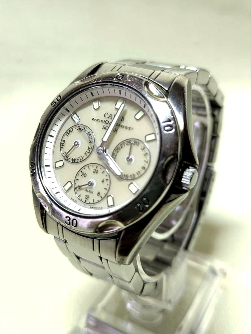 Silver Casio Carib SolarV14J 0A80 chronograph watch with date and day display on a wrist