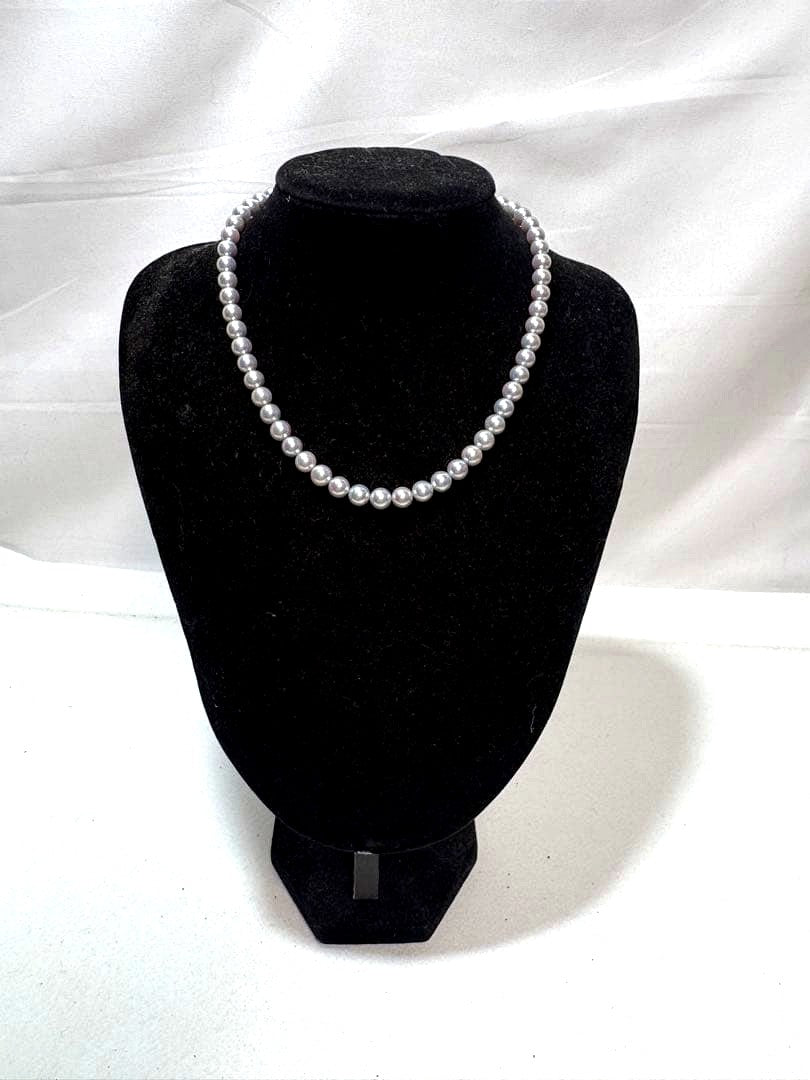 Akoya gray pearl necklace with silver chain on a white background
