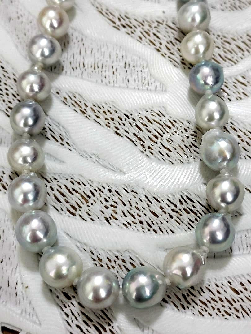 Akoya pearl large round necklace with multi-color pearls and silver push clasp on white background
