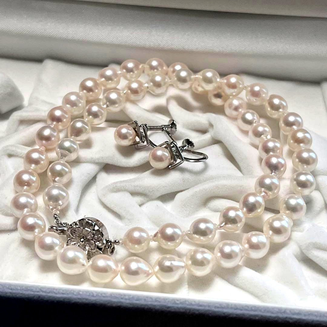 Akoya pearl necklace and matching earrings with pearls sized 6.5-7.0mm and 6.1mm on white background