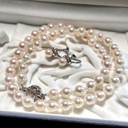 Akoya pearl necklace and matching earrings with pearls sized 6.5-7.0mm and 6.1mm on white background