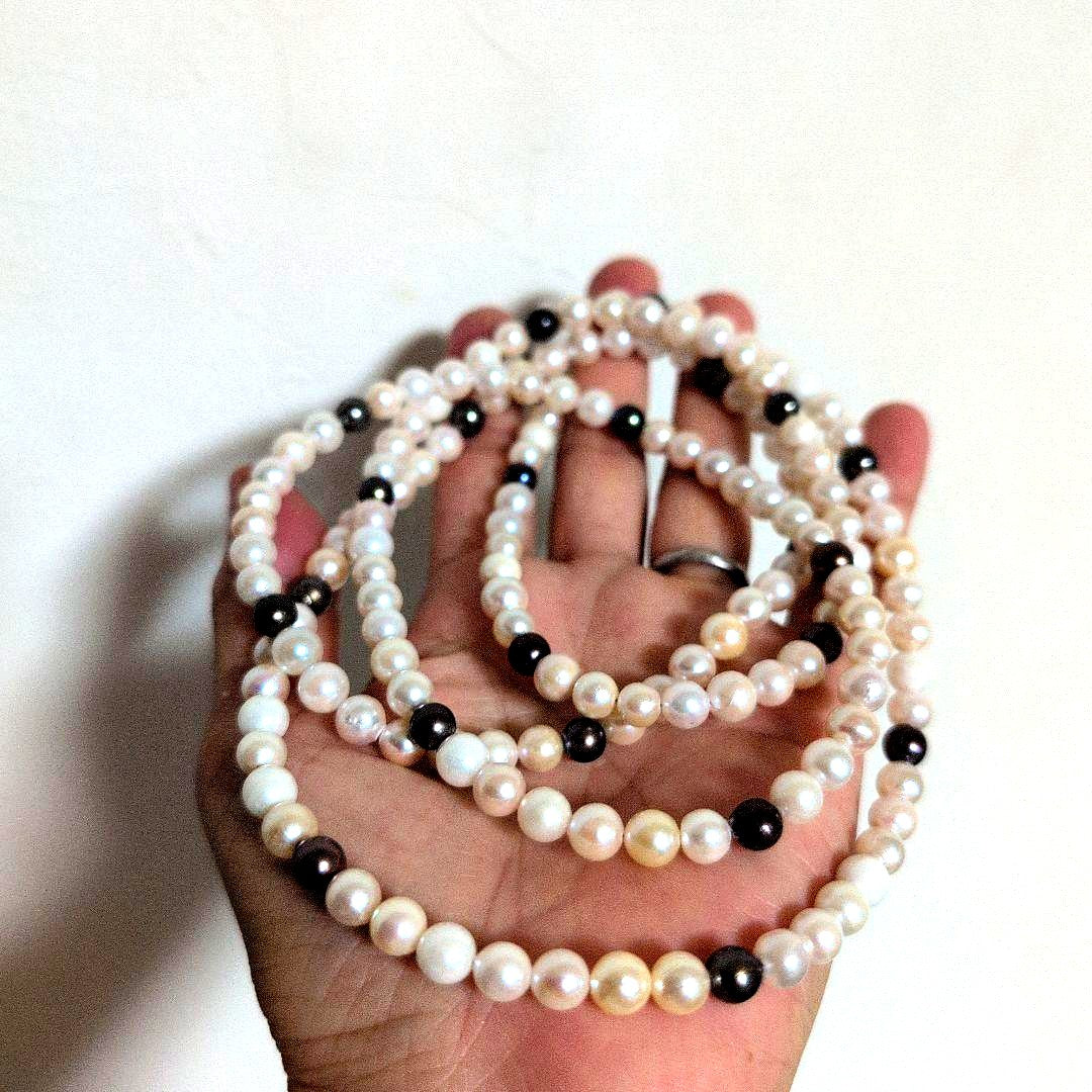 Akoya pearl long necklace with white and cream pearls sized 5.5 to 7 mm showing natural dents and wrinkles