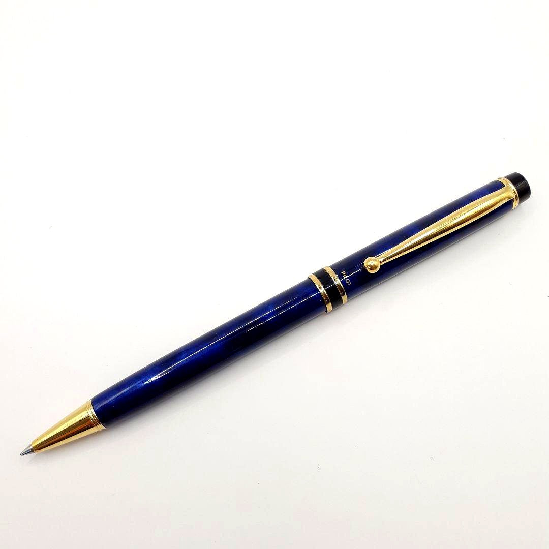 Used Pilot ballpoint pen in blue marble pattern with visible small scratches and paint chips