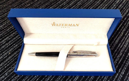 WATERMAN Paris ballpoint pen with silver wave pattern cap and black body beside a blue gift box