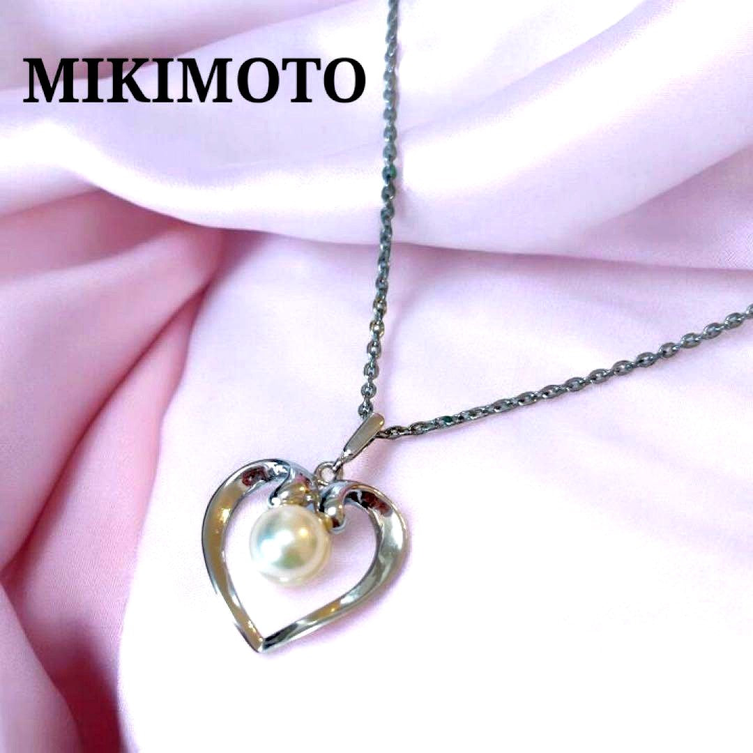 Mikimoto pearl necklace with silver heart pendant and 37 cm Akoya pearls on white background