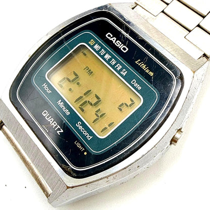 Vintage Casio 111QS-34 digital lithium quartz watch with showing scratches and plating peeling