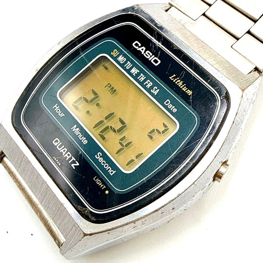 Vintage Casio 111QS-34 digital lithium quartz watch with showing scratches and plating peeling