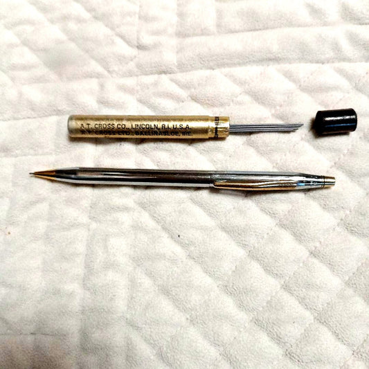 A.T. Cross silver and gold ballpoint pen made in USA shown with replacement refill
