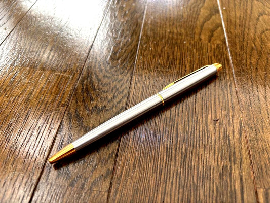 Waterman ballpoint pen in silver with gold metal parts and stripe design featuring a clip