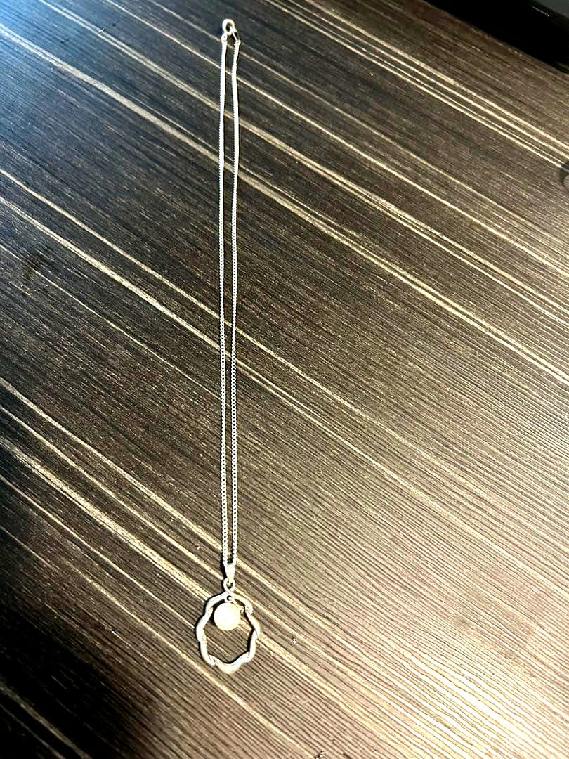 Mikimoto pearl necklace with approximately 7mm pearls measuring about 43cm in length on white background