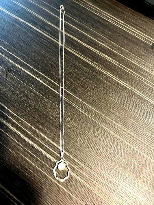 Mikimoto pearl necklace with approximately 7mm pearls measuring about 43cm in length on white background