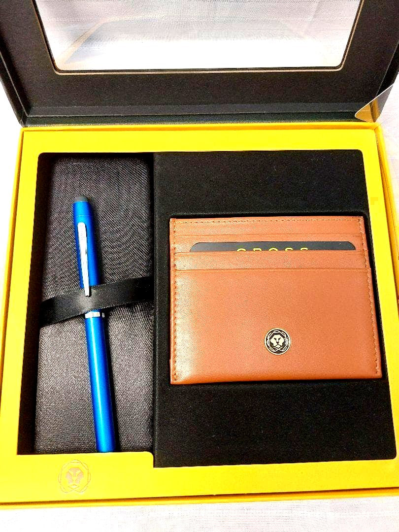 Cross ballpoint pen with blue brass resin body and chrome details alongside a brown leather card case