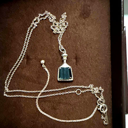 Agete necklace featuring labradorite and onyx stones with silver bottle-shaped pendant and charm