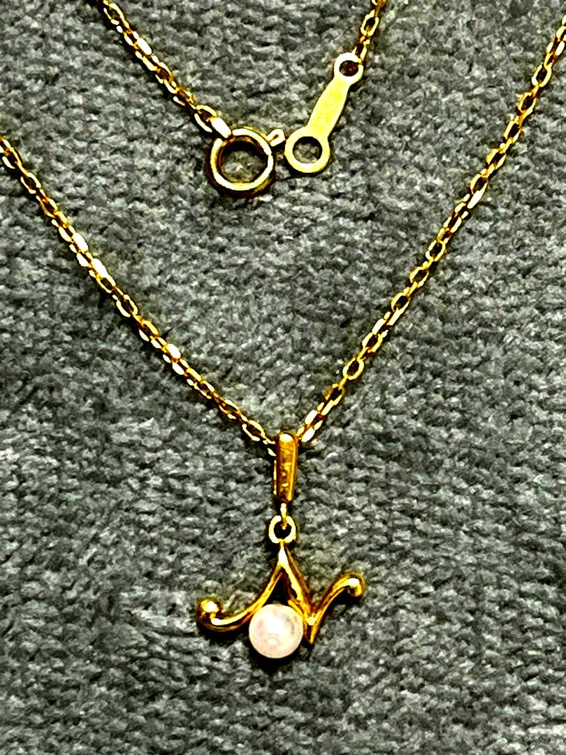 MIKIMOTO pearl necklace featuring 18k gold pendant, 38.5cm long, displayed on white background