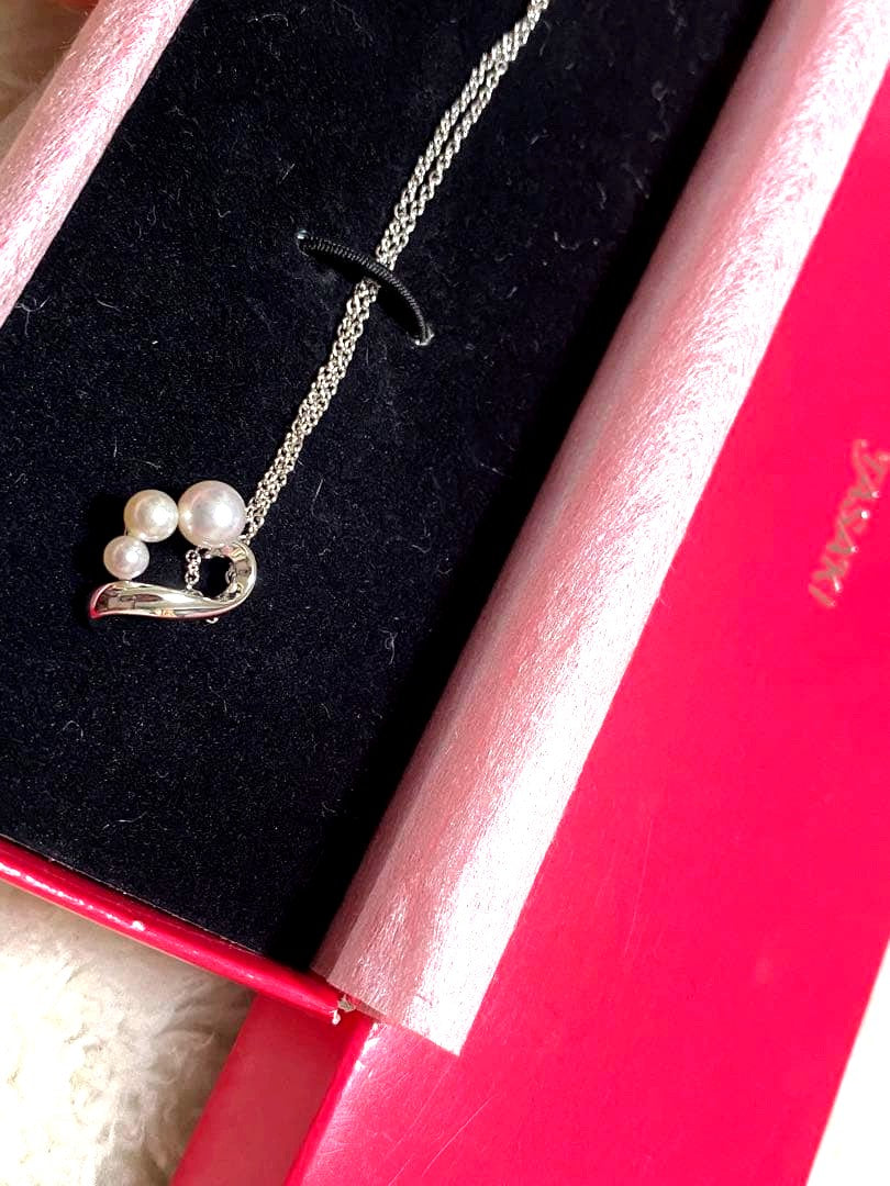 Tasaki pearl necklace made of silver SV925 with round white pearls displayed on a white background