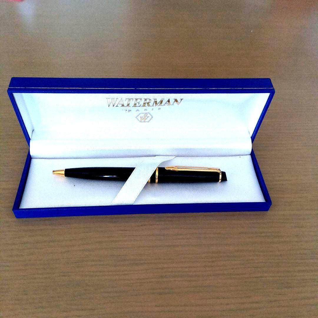 Waterman black ballpoint pen with gold metal fittings and plastic body displayed with dedicated case
