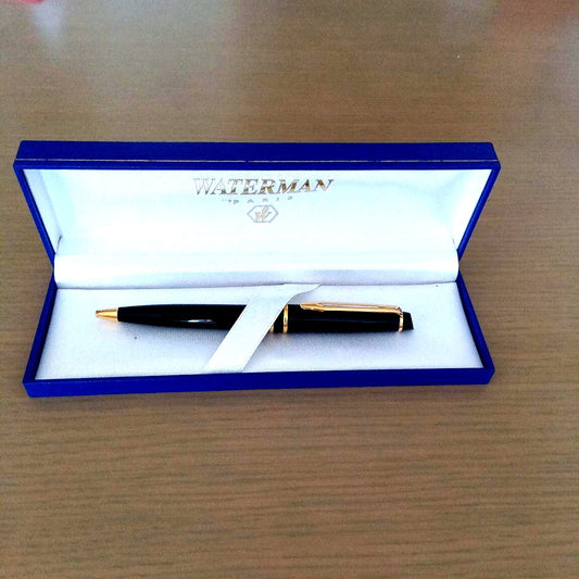 Waterman black ballpoint pen with gold metal fittings and plastic body displayed with dedicated case