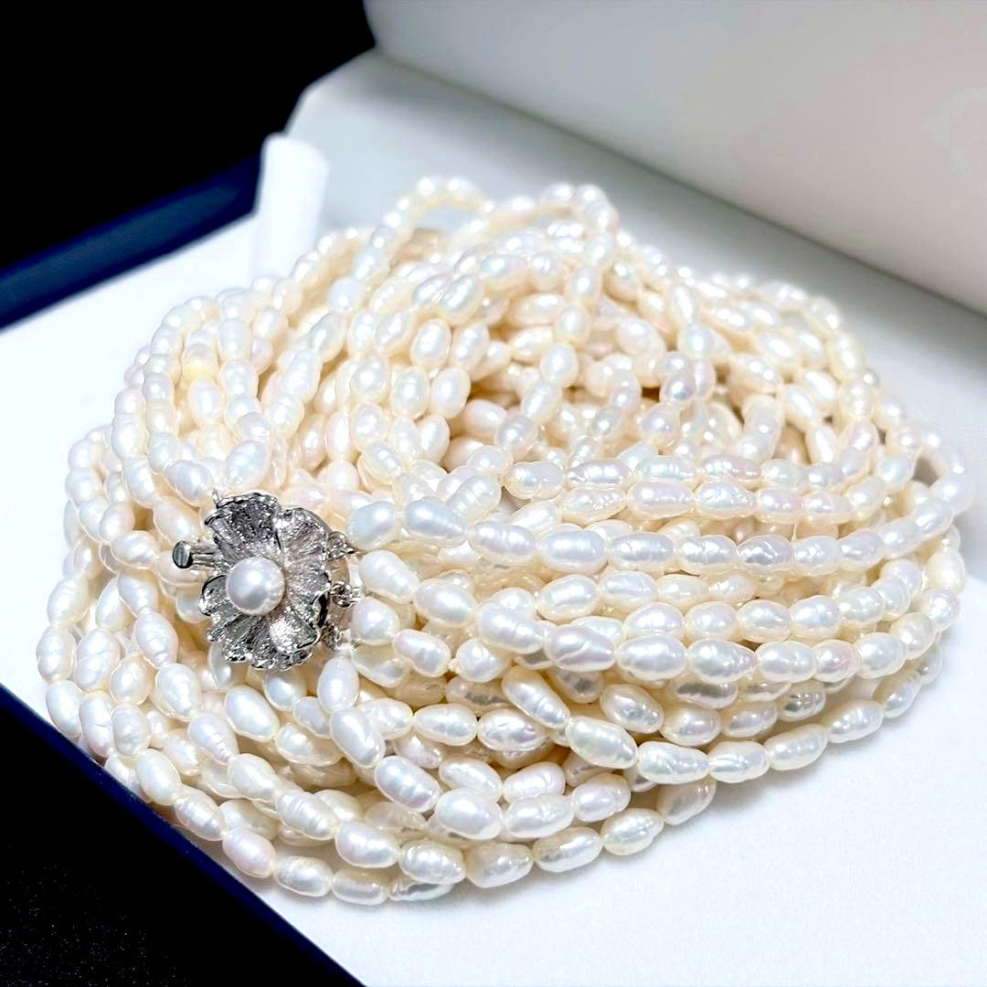 Akoya pearl 8-strand necklace with silver clasp displayed on a white background