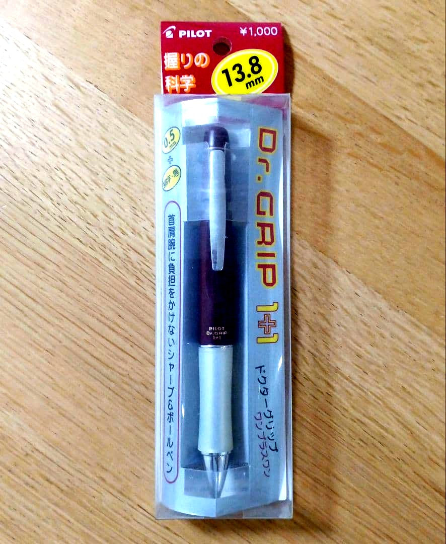 Pilot Dr. Grip 1+1 multi-function pen with dark red barrel, black 0.5mm ballpoint tip, and 0.5mm mechanical pencil