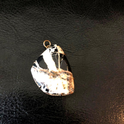 Agete Pendant Head made of stone with unique pattern shown on a chain