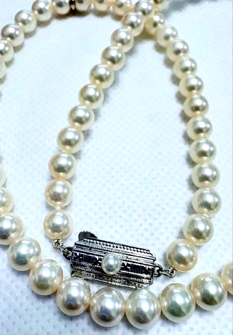 Mikimoto pearl necklace featuring 71 Akoya pearls sized 6.5 to 6.0mm with silver clasp and M logo charm