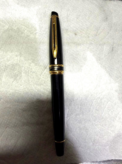Waterman Paris black gold fountain pen with sleek design and gold accents on a white background